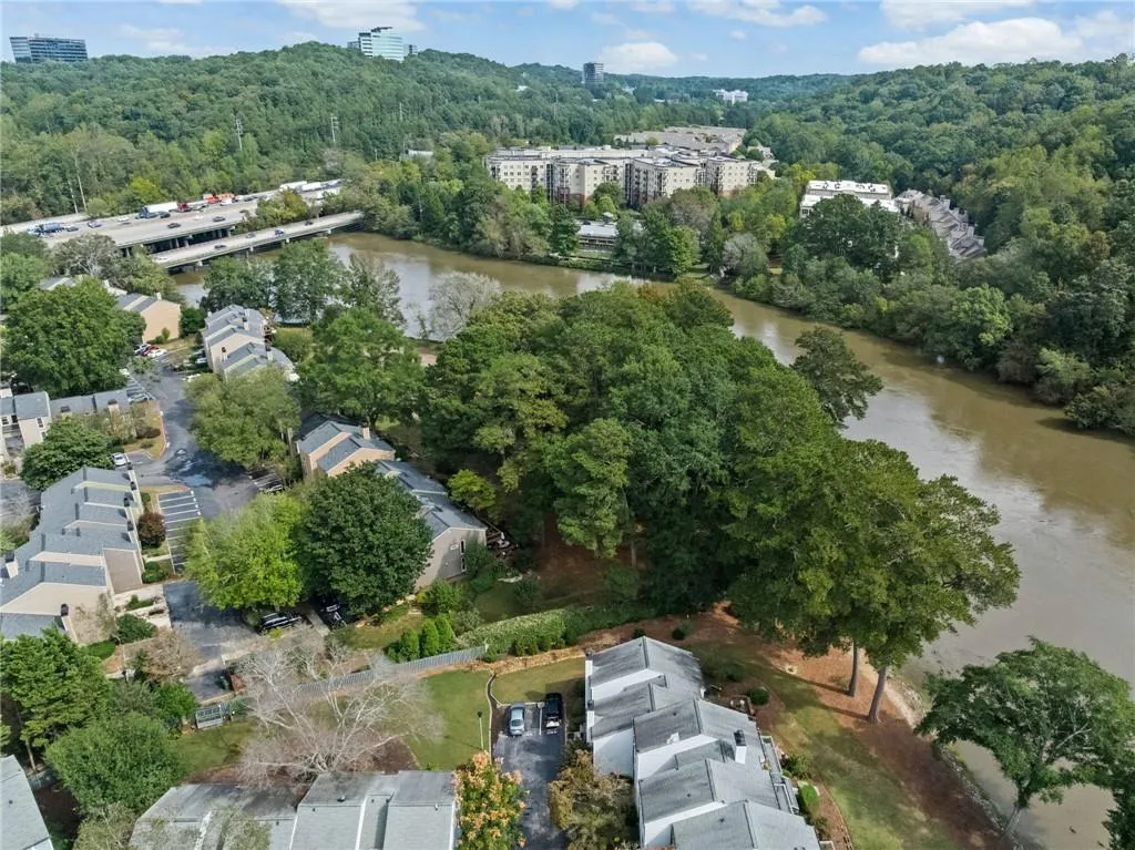 View of property location with a forest and a large body of water