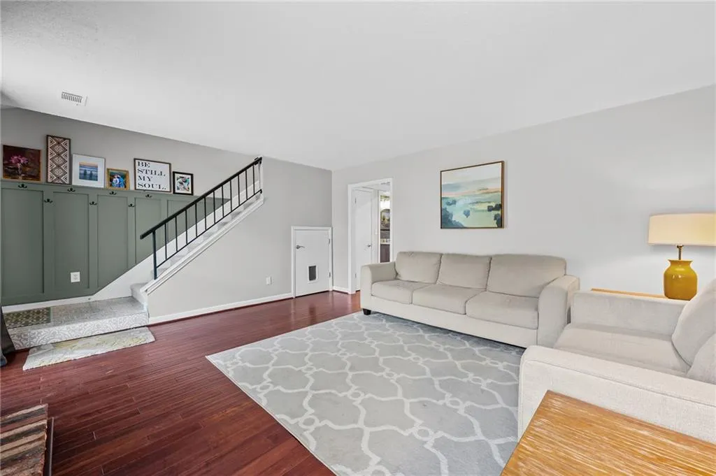 Living area featuring dark wood finished floors and stairs