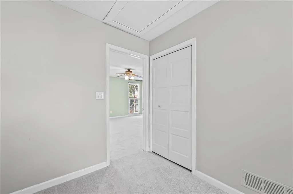 Unfurnished room with light colored carpet and baseboards
