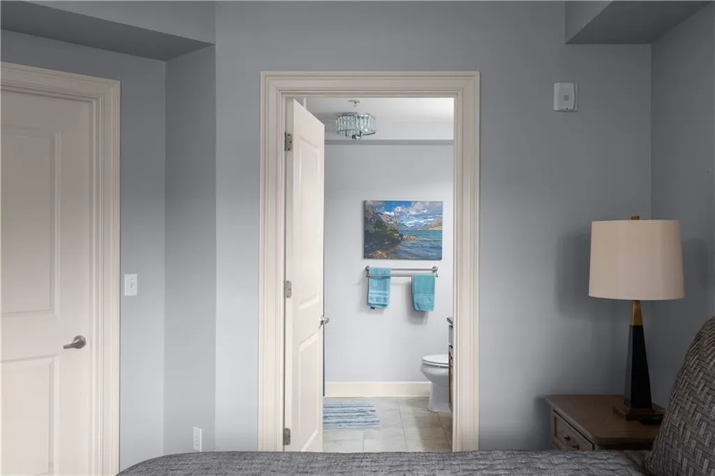 Half bathroom with toilet and light tile patterned floors