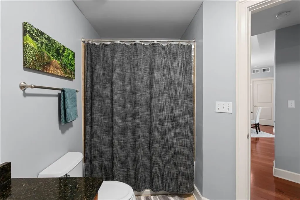 Bathroom featuring vanity, a shower with shower curtain, and light wood finished floors