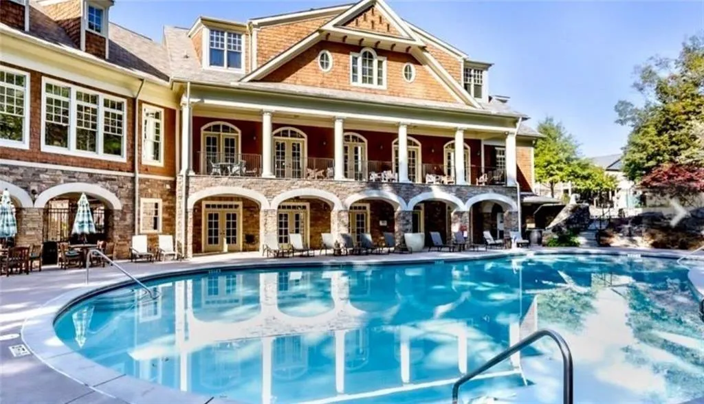Back of property with a community pool, a patio area, and french doors