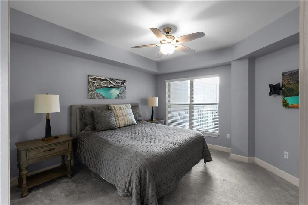 Bedroom with light colored carpet and ceiling fan