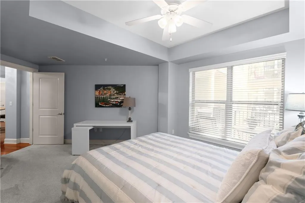 Bedroom with carpet floors and a ceiling fan