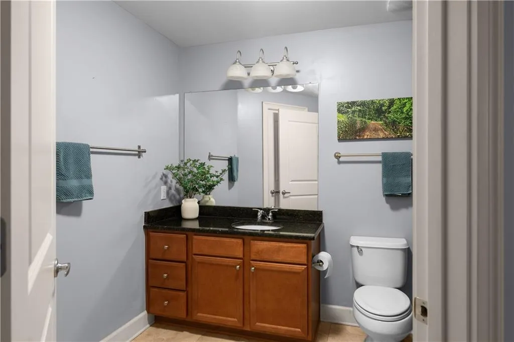 Half bath featuring vanity and light tile patterned floors