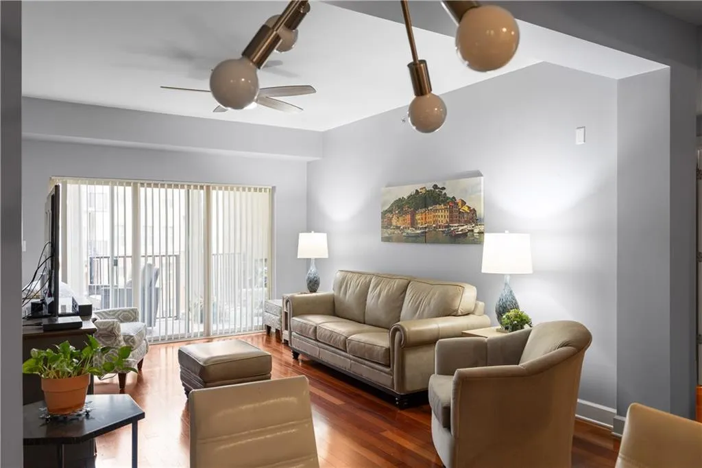 Living room with wood-type flooring and ceiling fan