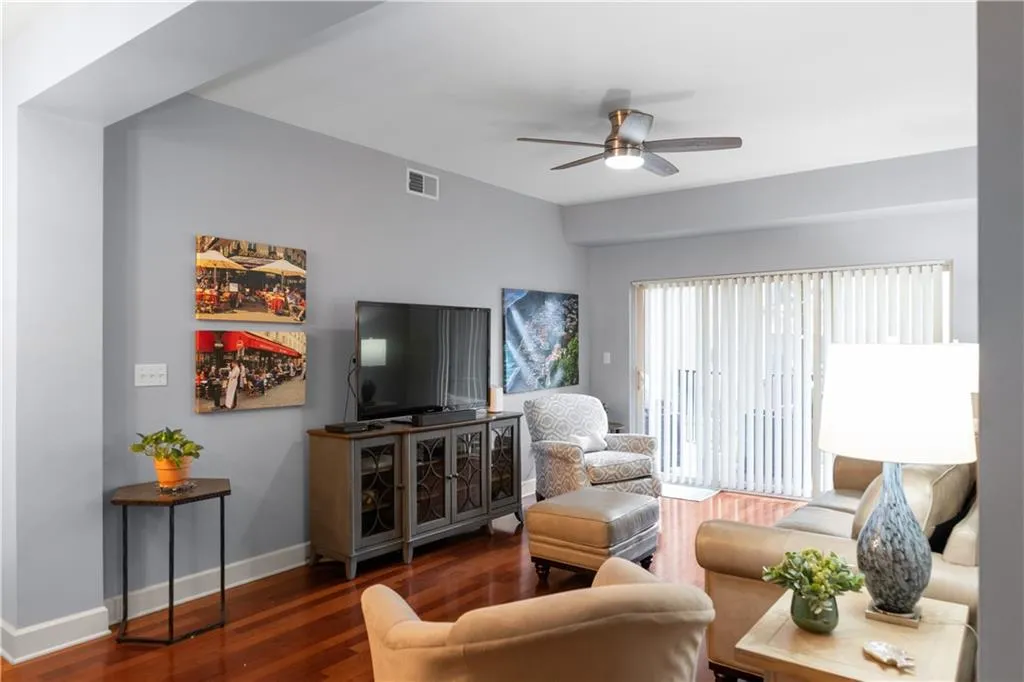 Living area with ceiling fan and hardwood / wood-style floors