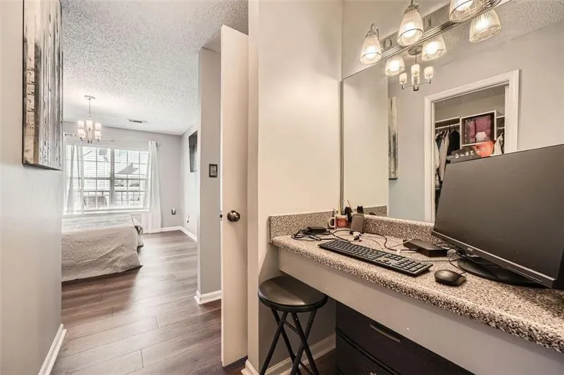 Bathroom featuring a chandelier, a textured ceiling, and dark wood finished floors