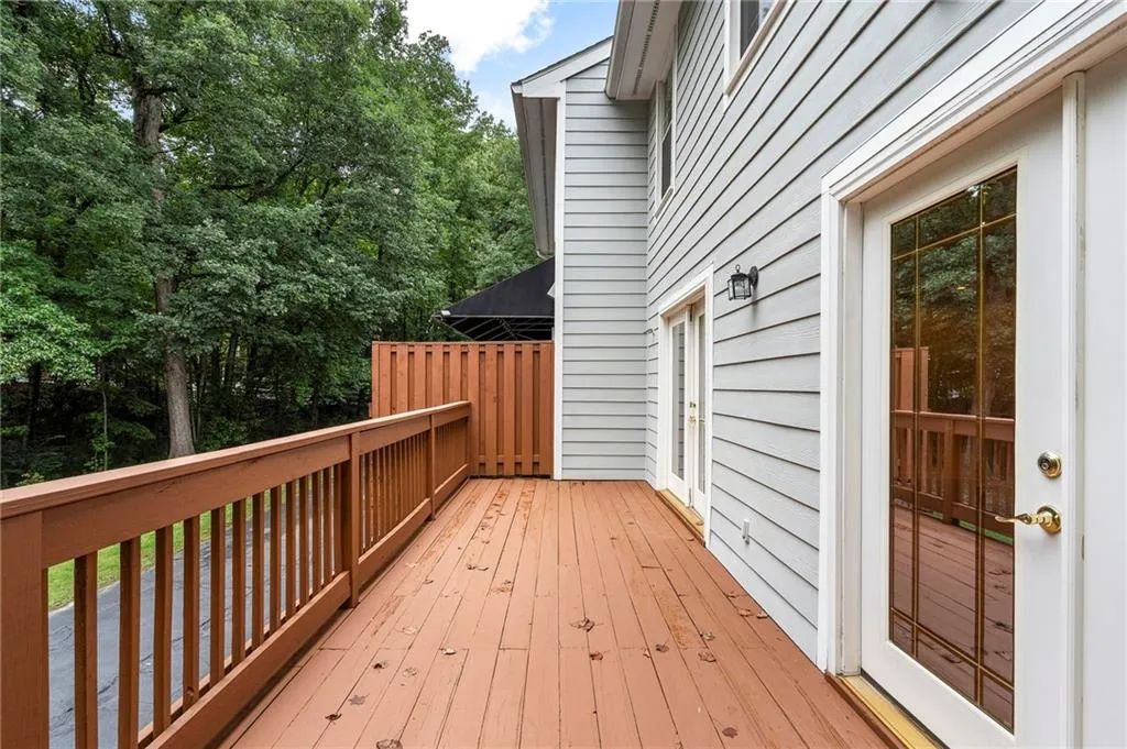 Patio off kitchen and family room overlooks the properties natural area and provides privacy.