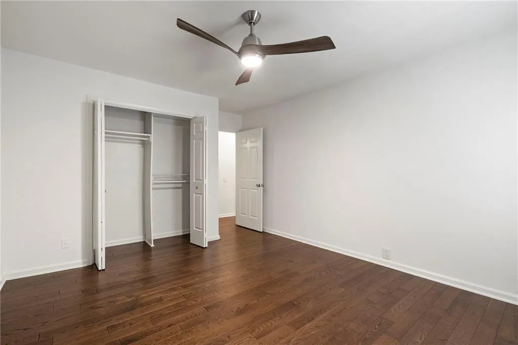 3 of 3 secondary bedrooms on the 3rd floor with hardwood floors, a new ceiling fan  natural light and all freshly painted