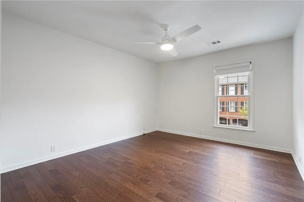 2 of 3 secondary bedrooms on the 3rd floor with hardwood floors and a new ceiling fan