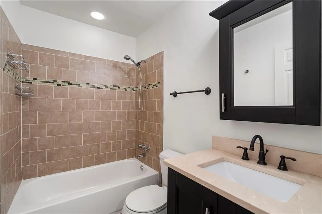 3rd floor shared bath with vanity and shower / bath combination