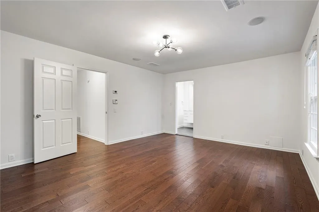 Upstairs Primary retreat with hardwood floors and an abundance of natural light