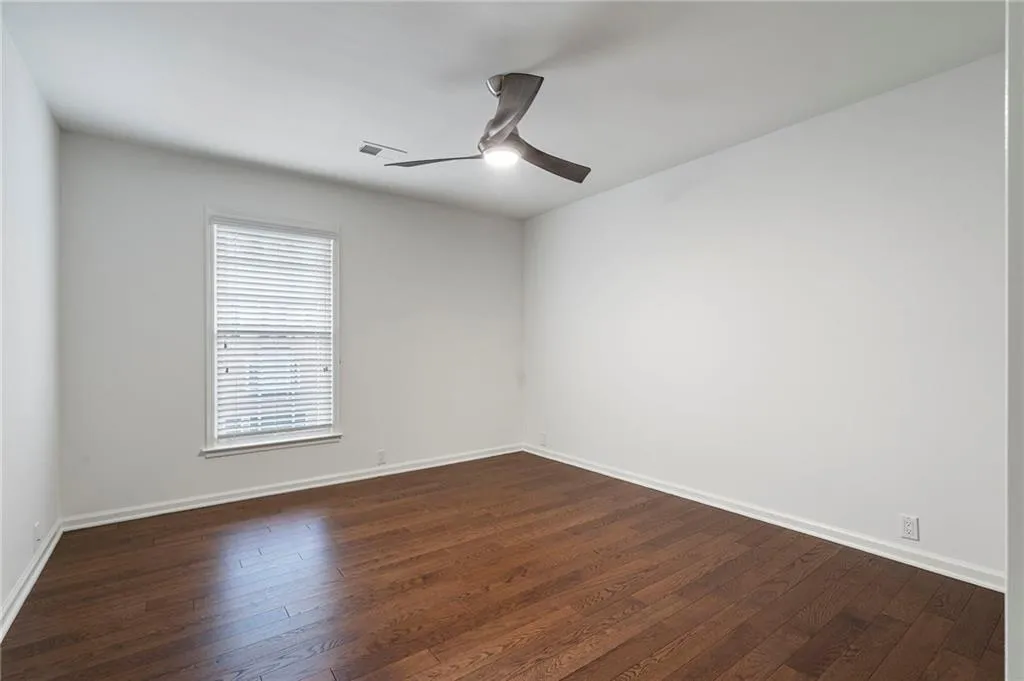 3 of 3 secondary bedrooms on the 3rd floor with hardwood floors, a new ceiling fan  natural light and all freshly painted