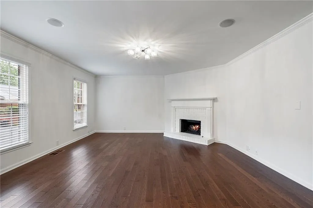 Oversized formal living room with a working gas fireplace and Harwood floors is ready for you to move in and entertain!