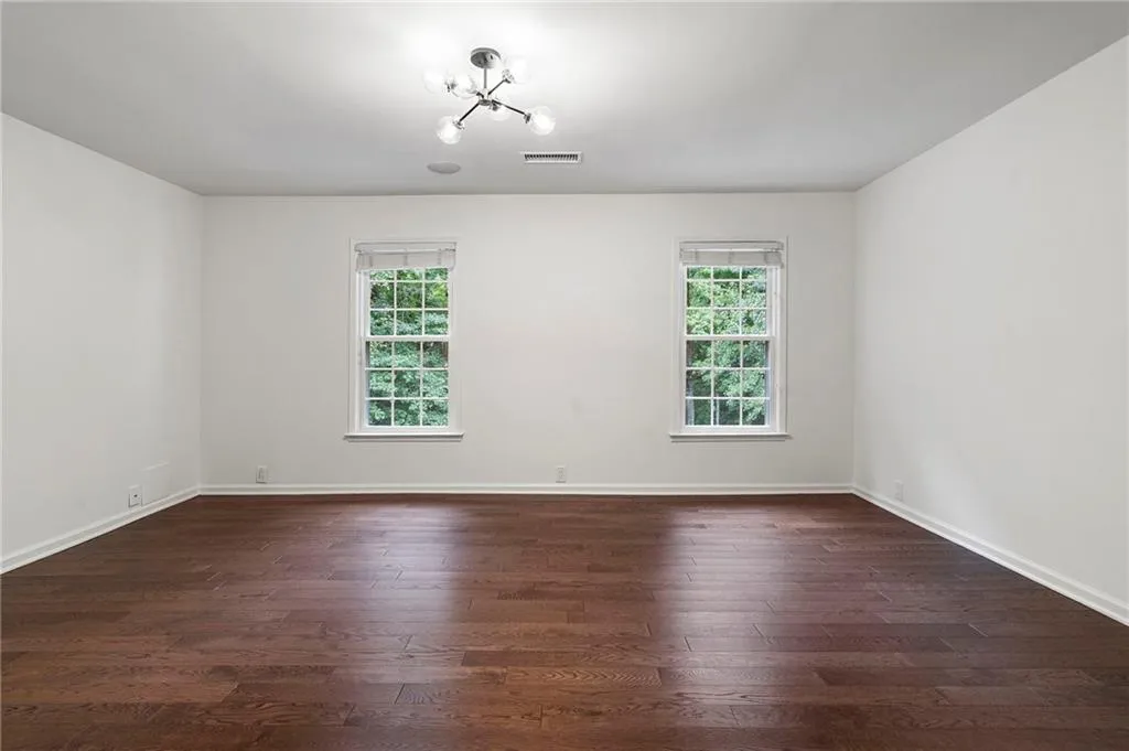 Upstairs Primary retreat with hardwood floors and an abundance of natural light
