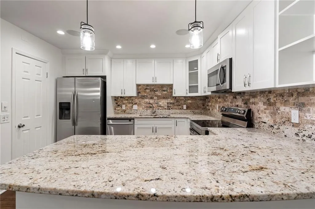 Oversized peninsula offers extra prep space and a countertop bar breakfast bar.