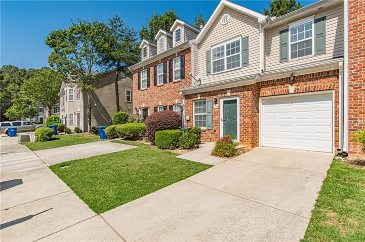 Brick and siding exterior with a single-car garage and concrete driveway