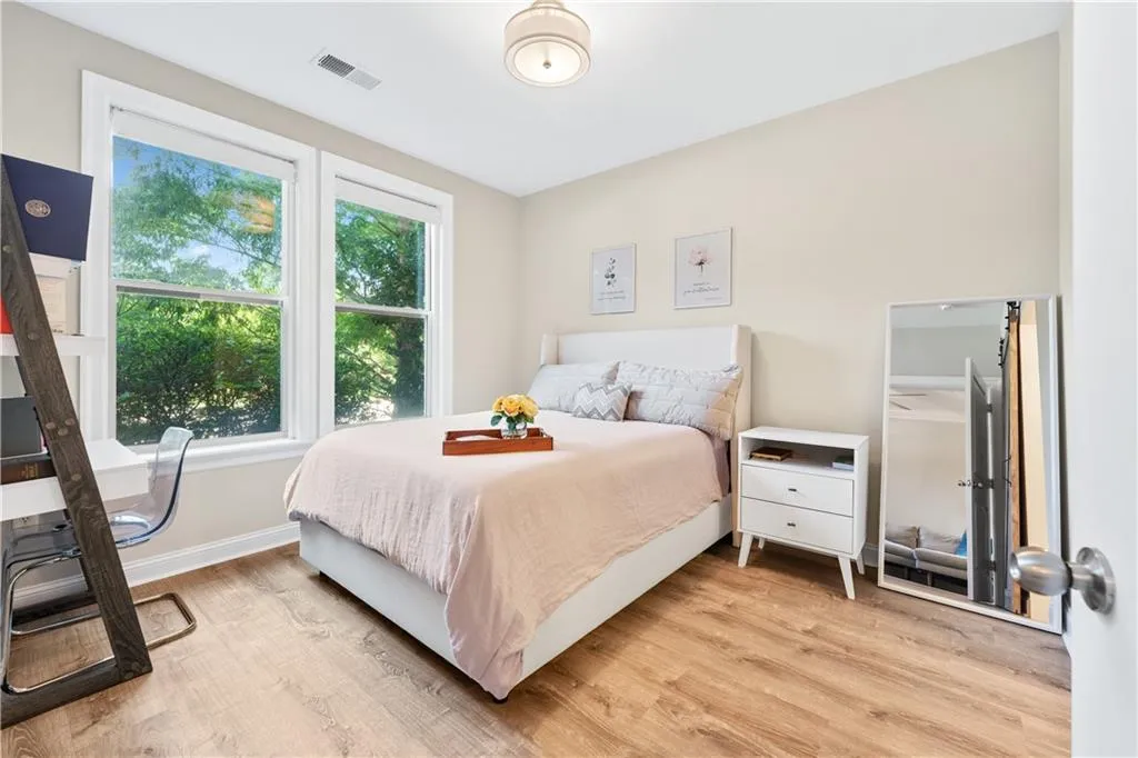 Bedroom with light wood finished floors and natural light