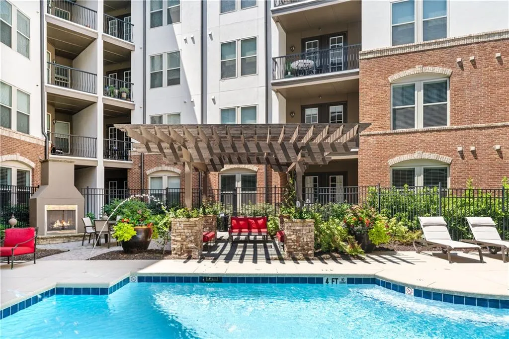 Community pool featuring a patio area, a pergola, and a warm lit fireplace