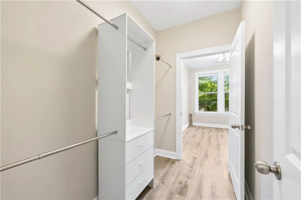 Spacious closet with light wood-style floors