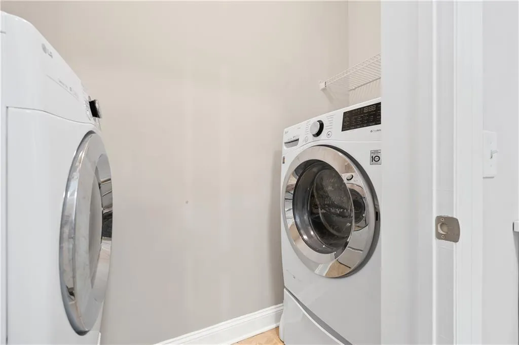 Laundry area featuring separate washer and dryer and tile patterned floors