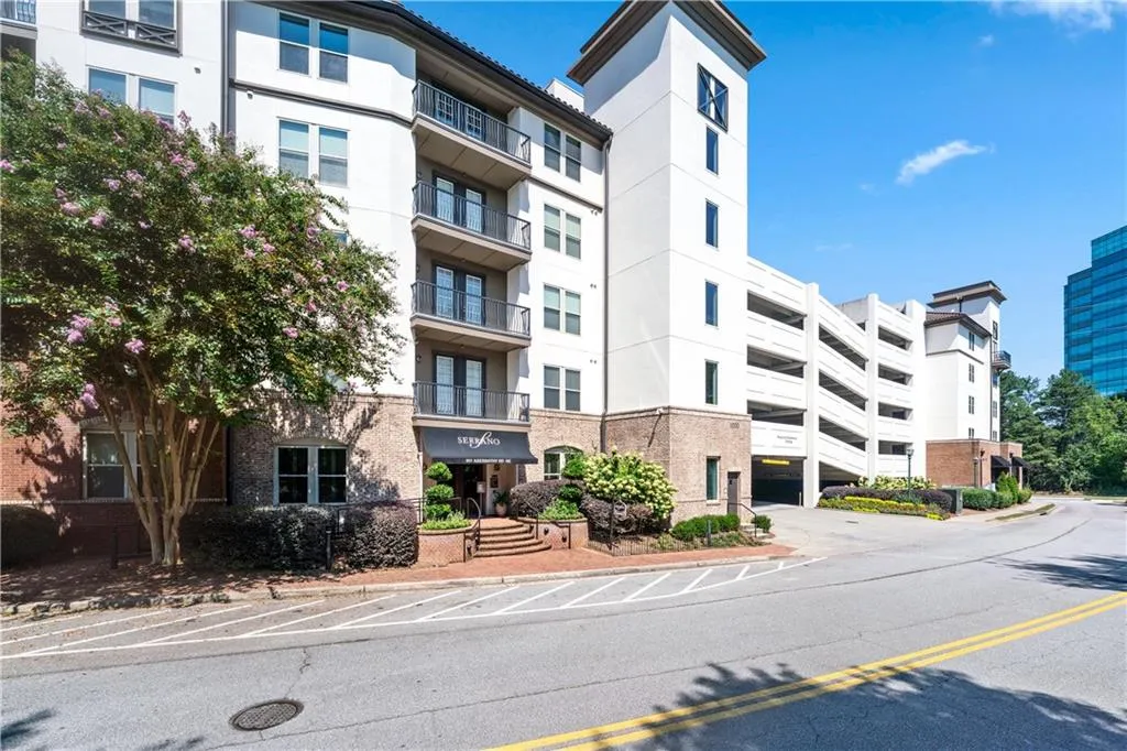 View of apartment building / complex with uncovered parking