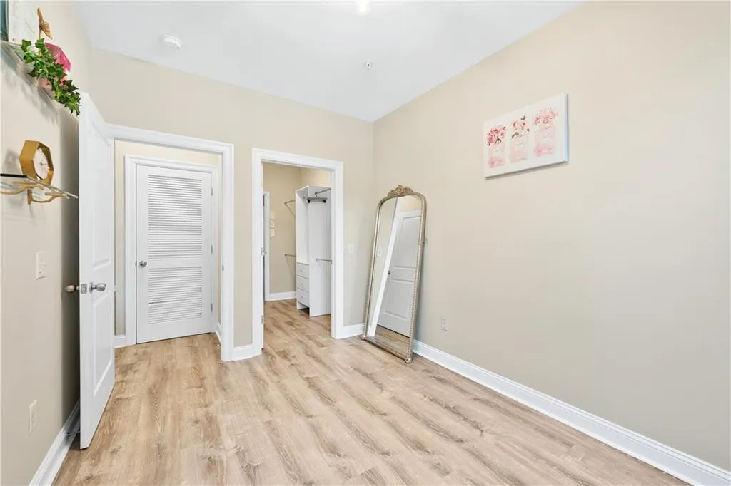 Unfurnished bedroom with light wood-type flooring and baseboards