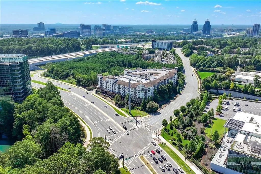 View of urban area featuring a tree filled landscape and a highway