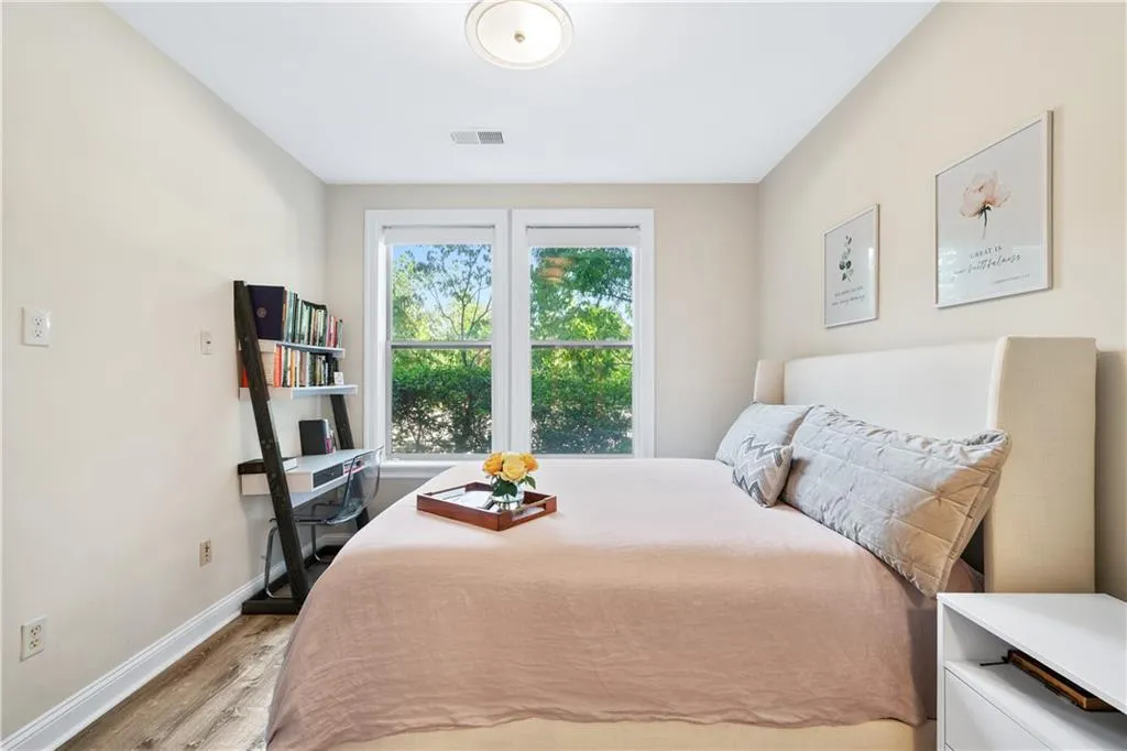 Bedroom with baseboards and wood finished floors