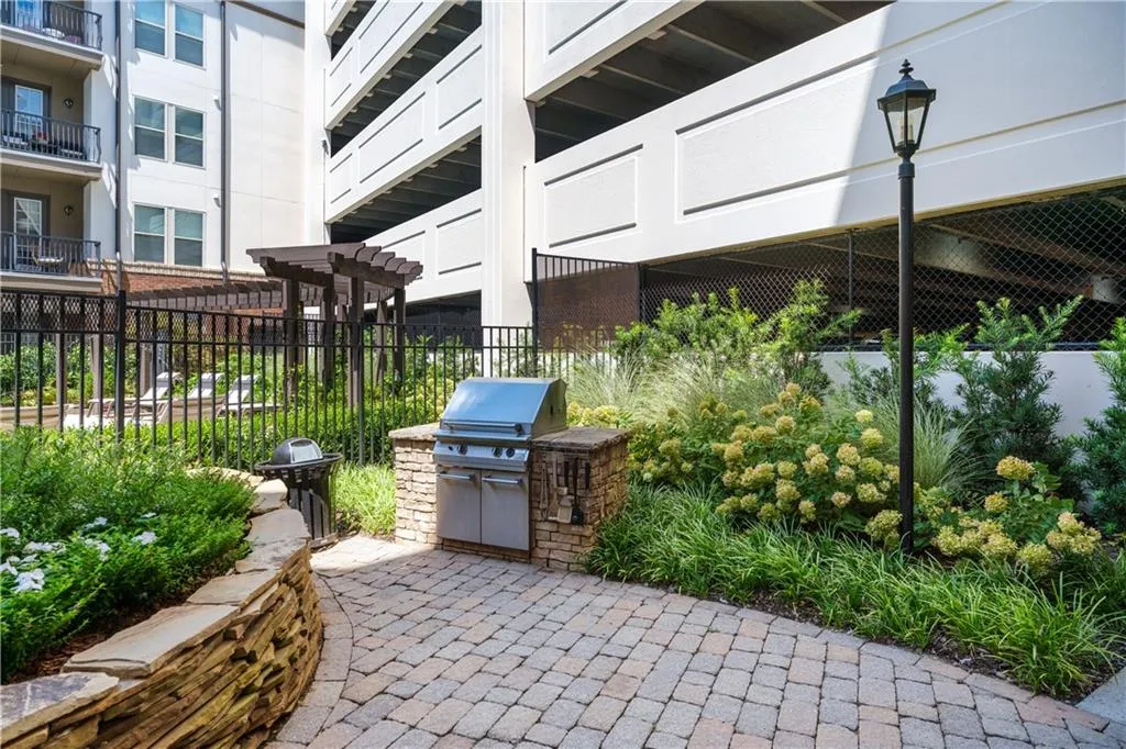 View of patio with an outdoor kitchen and a pergola