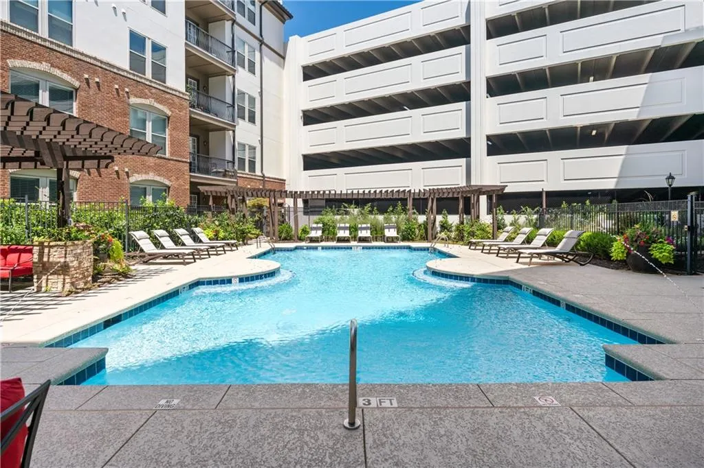 Community pool with a pergola and a patio