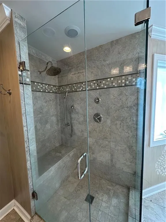 Full bathroom featuring a shower stall