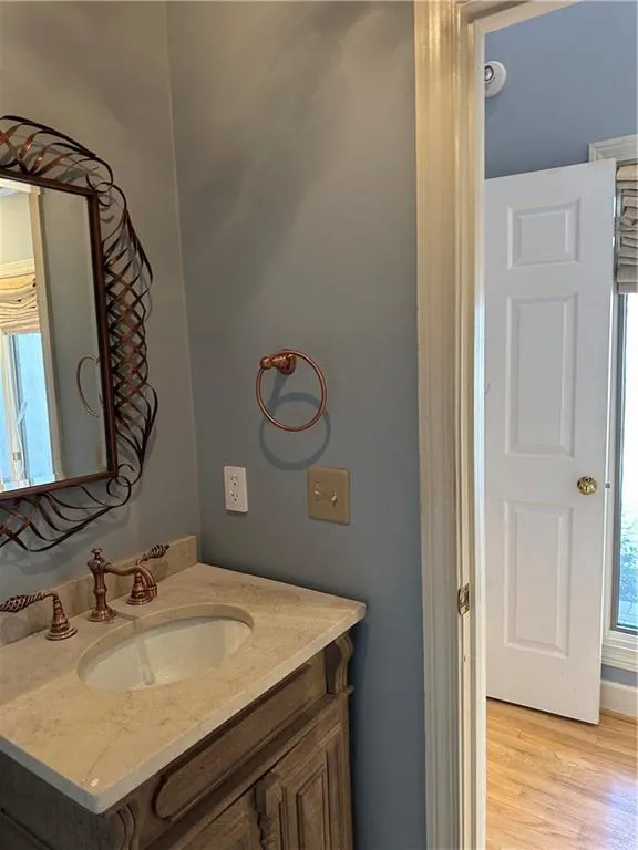 Bathroom with vanity and wood finished floors