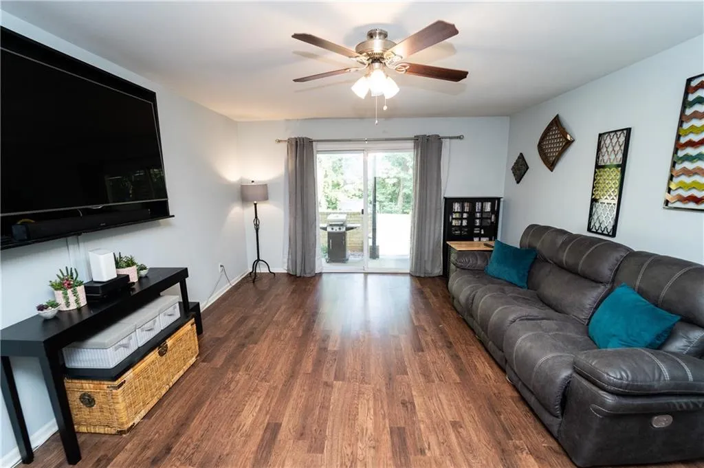 Living area featuring ceiling fan and wood finished floors