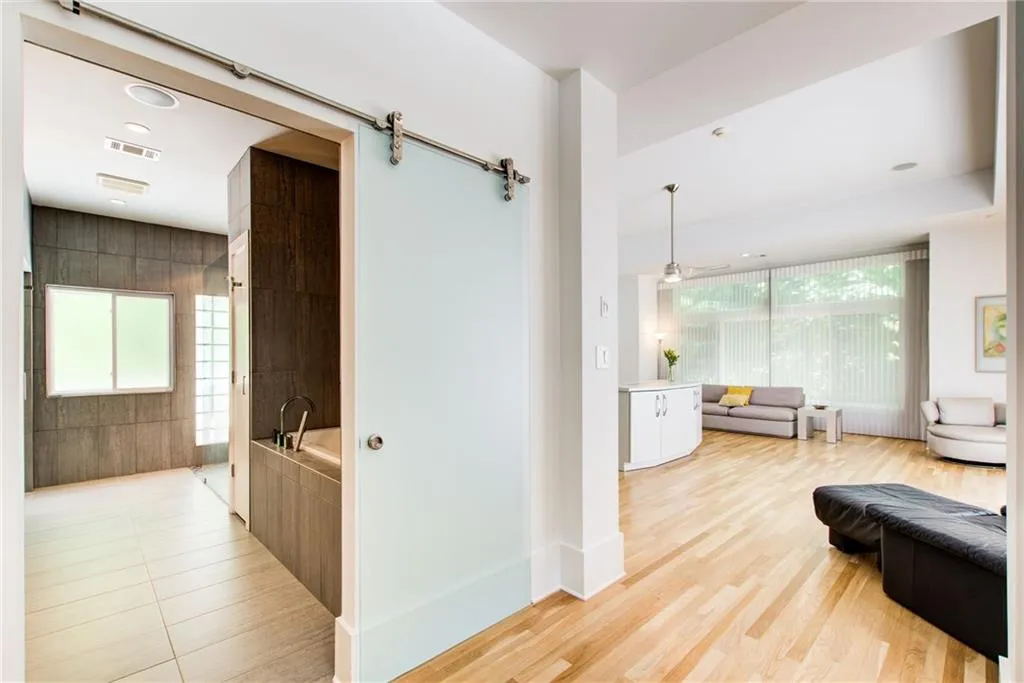 Frosted barn door for privacy at the primary bathroom