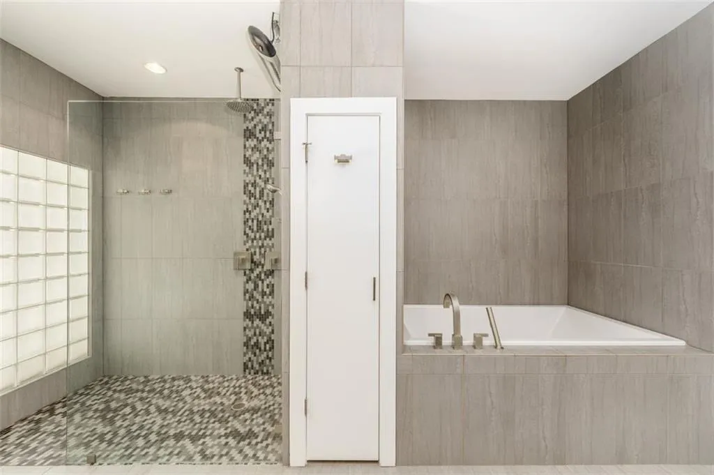 Soaking tub and frameless shower that even has a heater.