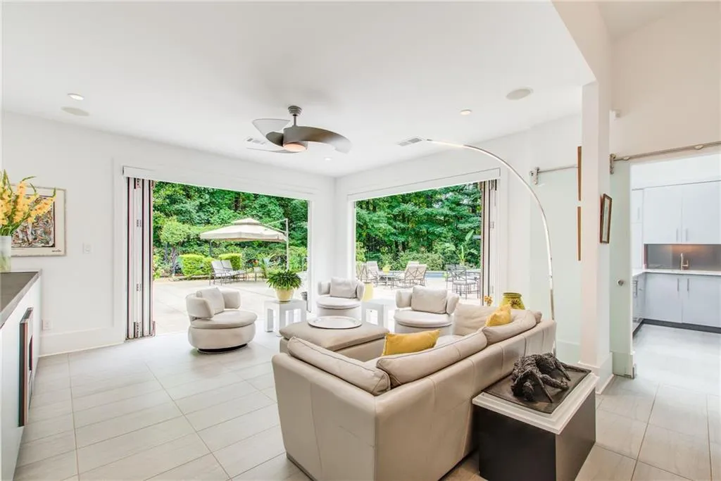 The fireside family room has accordion glass doors to open to let the outside in.