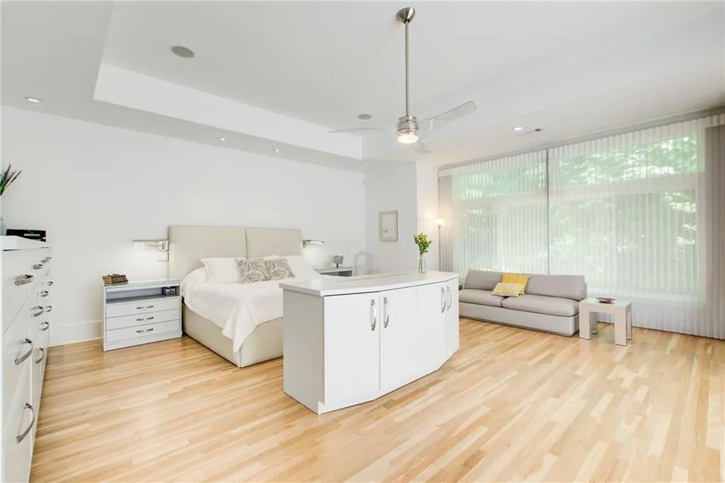 KING SIZE primary retreat with tray ceiling and walls of glass. Your own sanctuary.