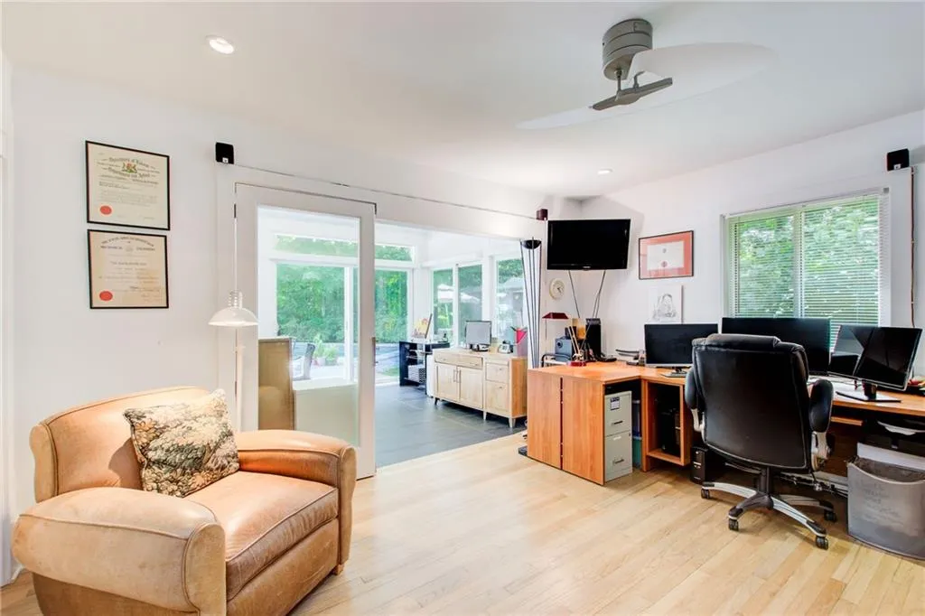 Main floor Office/bedroom with two closets with glass doors to 4 seasons room