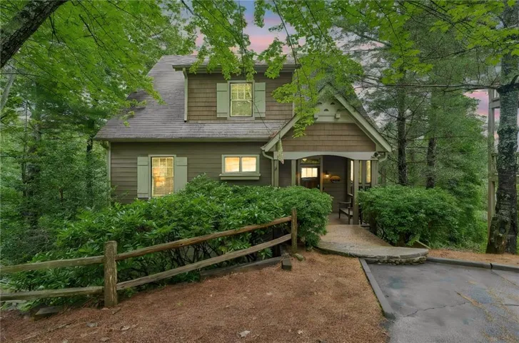 Craftsman-style exterior featuring a covered porch entrance, horizontal siding, shake siding accents, and decorative window shutters