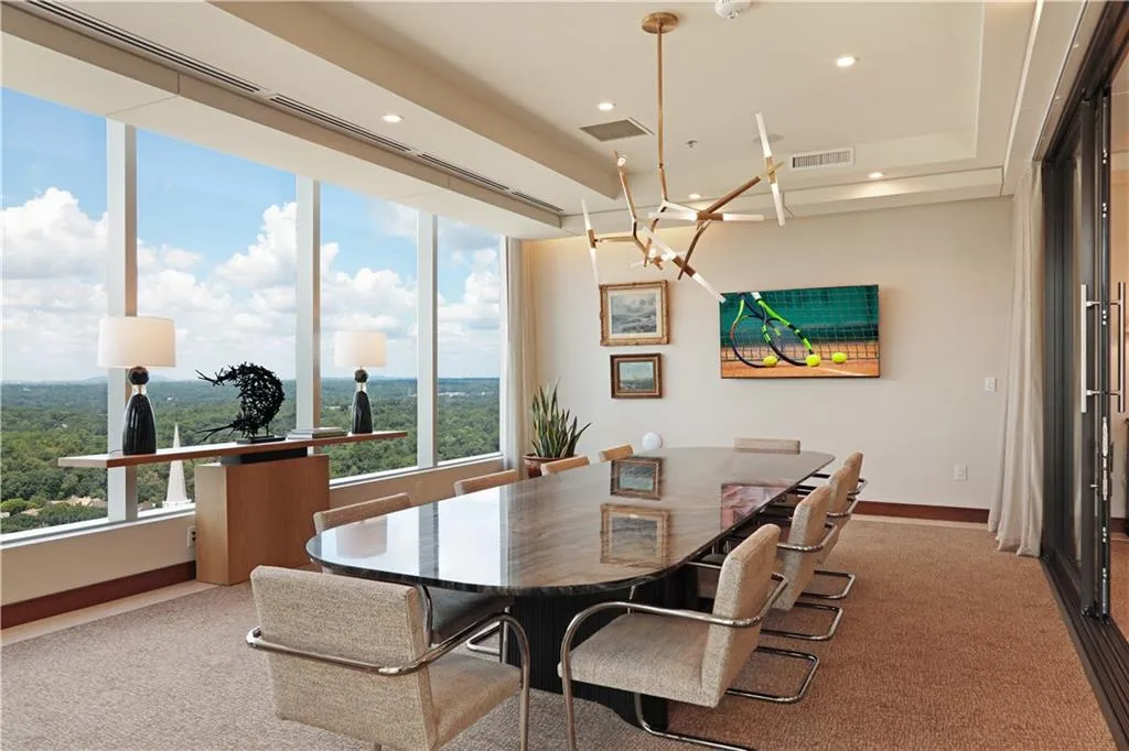 Dining room featuring a chandelier, recessed lighting, a raised ceiling, and light carpet