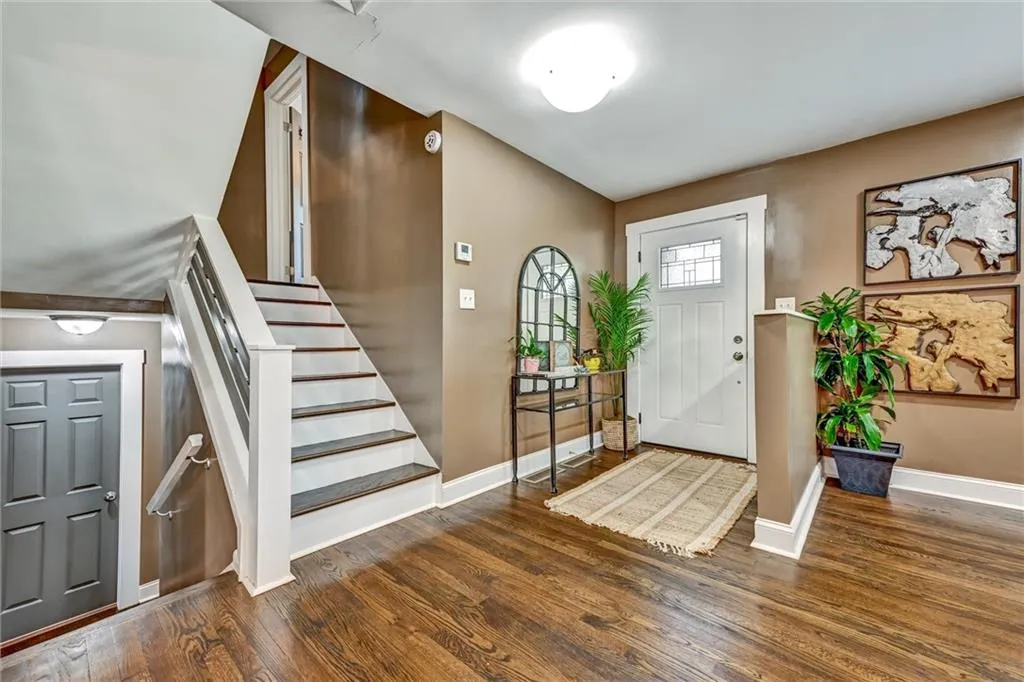Foyer with dark hardwood / wood-style flooring
