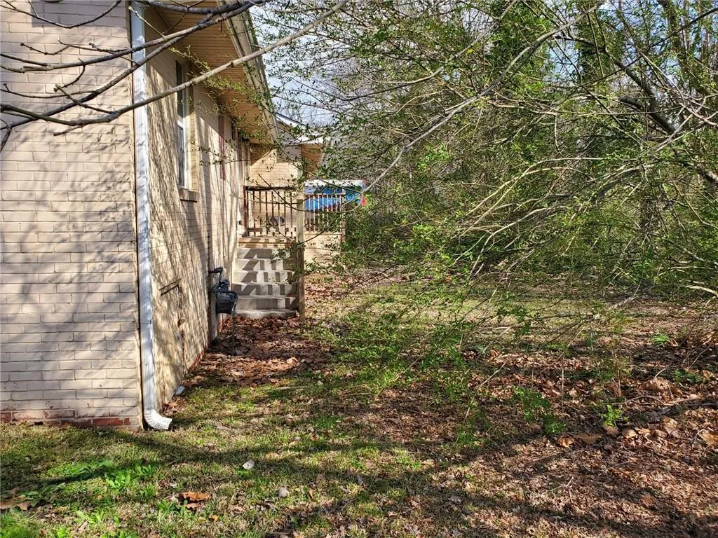 View of side of property featuring brick siding