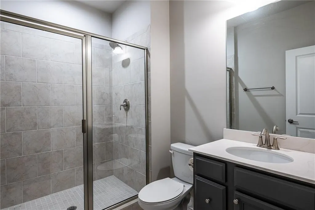 Bathroom with vanity and a stall shower