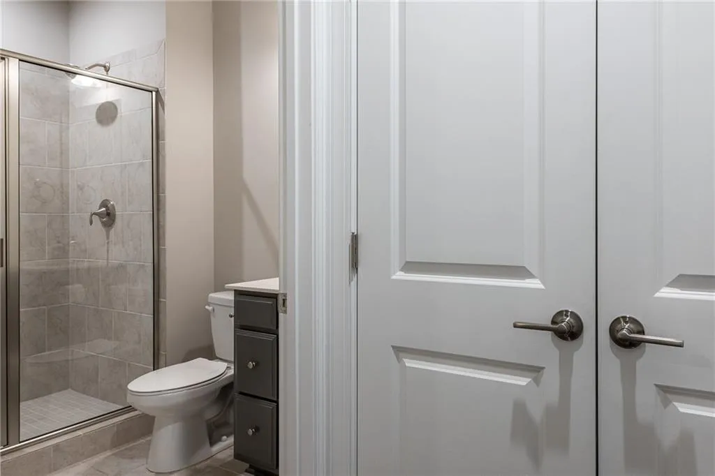 Bathroom with a stall shower, vanity, and tile patterned floors