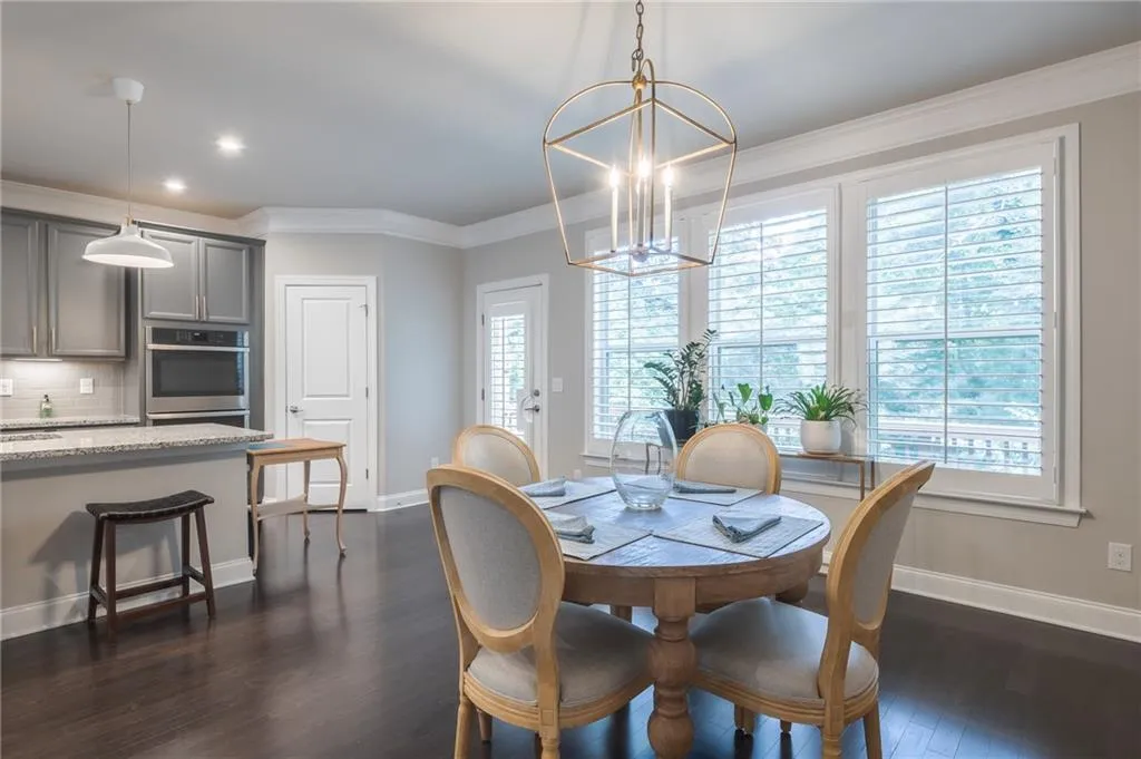 Dining space featuring a chandelier, recessed lighting, ornamental molding, and dark wood-type flooring