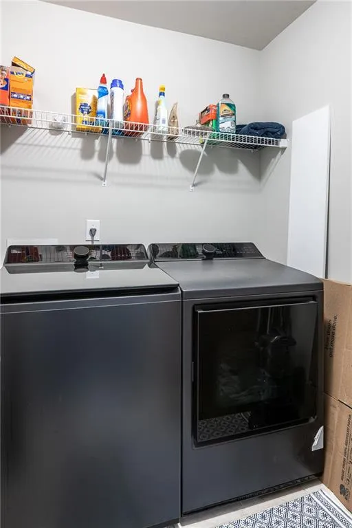 Laundry area with washing machine and clothes dryer