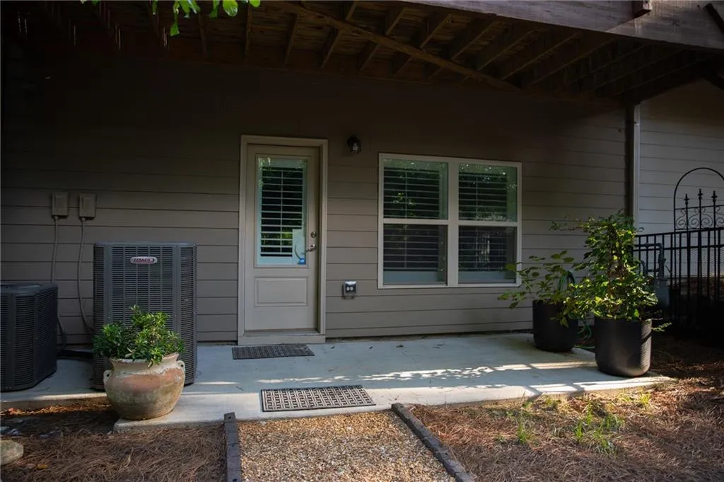 View of exterior entry with a patio