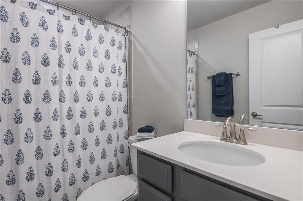 Bathroom with vanity and a shower with shower curtain